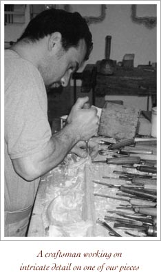 A craftsman working on intricate detail on one of our pieces